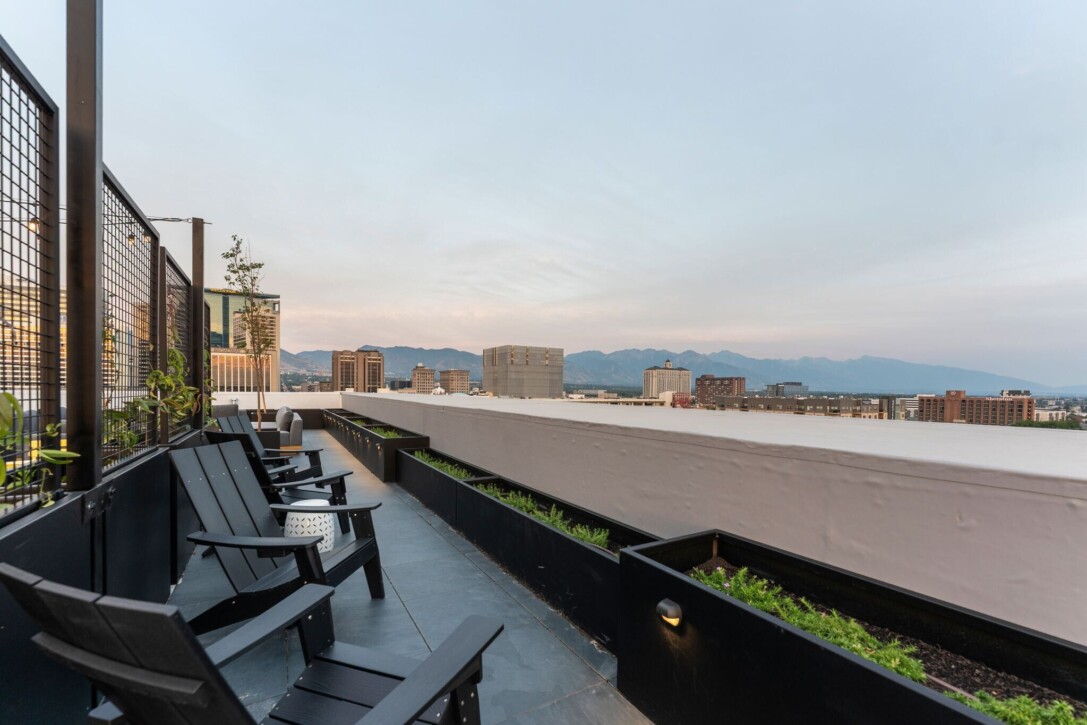 Outdoor fire pit lounge featuring Mbrico porcelain rooftop decking and Salt Lake City skyline views